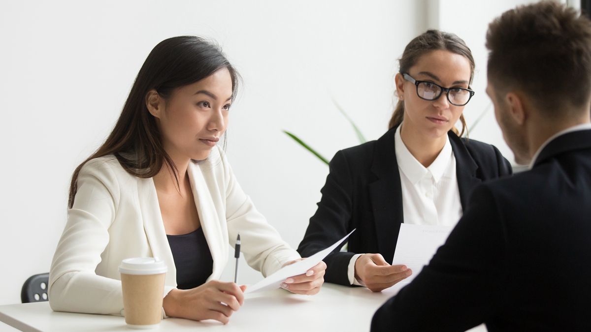 Colleagues discussing business plan in office Serious concerned HR managers listening attentively to applicant thoughts and ideas. Colleagues discussing business plan strategy on board meeting. Concept of cooperation, employment, hiring